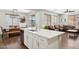 Open-concept kitchen with stainless appliances, white island, and adjacent dining and living spaces at 2096 S Moccasin Trl, Gilbert, AZ 85295