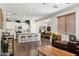 Open-concept living space with hardwood floors, views into the kitchen, and comfortable seating at 2096 S Moccasin Trl, Gilbert, AZ 85295