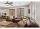 Bright living room featuring a plush leather sectional and ample light from the windows at 2096 S Moccasin Trl, Gilbert, AZ 85295