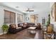 Spacious living room with hardwood floors, large sectional sofa, and ample natural light at 2096 S Moccasin Trl, Gilbert, AZ 85295