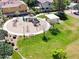 Community playground with a variety of play structures, green space, and shaded picnic area for families at 2096 S Moccasin Trl, Gilbert, AZ 85295