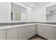 Bathroom featuring gray backsplash, light-tone cabinets and quartz countertops at 225 W Winged Foot Rd, Phoenix, AZ 85023