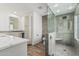 Modern bathroom with quartz countertop vanity and glass-enclosed shower with a bench at 225 W Winged Foot Rd, Phoenix, AZ 85023