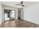 Bedroom featuring sliding glass doors with patio views, wood-look floors, and ceiling fan at 225 W Winged Foot Rd, Phoenix, AZ 85023