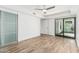 Spacious bedroom featuring glass slider doors, wood-look floors and a ceiling fan at 225 W Winged Foot Rd, Phoenix, AZ 85023