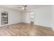 Light and airy bedroom featuring wood-look tile flooring and barn door access to the closet at 225 W Winged Foot Rd, Phoenix, AZ 85023
