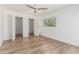 Bright bedroom with wood-look floors and a window offering green views at 225 W Winged Foot Rd, Phoenix, AZ 85023