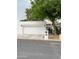 Contemporary home with a white stucco exterior, two car garage, and mature shade tree at 225 W Winged Foot Rd, Phoenix, AZ 85023