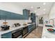 Well-lit modern kitchen with stainless steel appliances, custom cabinets and quartz countertops at 225 W Winged Foot Rd, Phoenix, AZ 85023