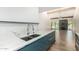 Kitchen island with quartz countertop and stainless steel sink with open floorplan in the background at 225 W Winged Foot Rd, Phoenix, AZ 85023