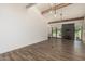 Spacious living room with wood floors, fireplace, wet bar, ceiling fan, and bright sliding doors at 225 W Winged Foot Rd, Phoenix, AZ 85023