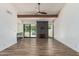Bright living room featuring wood flooring, fireplace, wet bar, and sliding doors to backyard at 225 W Winged Foot Rd, Phoenix, AZ 85023