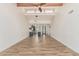 Expansive living room features vaulted ceilings with beams, modern lighting, and open kitchen view at 225 W Winged Foot Rd, Phoenix, AZ 85023