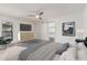 Airy main bedroom showcasing a ceiling fan, neutral colors, and walk-in closet for ample storage at 225 W Winged Foot Rd, Phoenix, AZ 85023