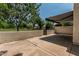 Open-air patio space offers a peaceful view of the lush green lawn and mature trees, perfect for outdoor living at 225 W Winged Foot Rd, Phoenix, AZ 85023