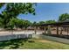 Community pool area enclosed by iron fencing and a covered lounging area for residents to enjoy at 225 W Winged Foot Rd, Phoenix, AZ 85023
