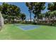 Well-maintained tennis court surrounded by lush greenery, creating a serene and active recreational space at 225 W Winged Foot Rd, Phoenix, AZ 85023