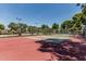 Community tennis court with well-maintained surface and mature trees at 225 W Winged Foot Rd, Phoenix, AZ 85023