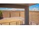 View of a backyard with a stone wall, rocks, a small patch of grass and mountain views at 25732 W Elizabeth Ave, Buckeye, AZ 85326