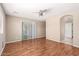 Open-concept bedroom features laminate flooring and access to a patio through sliding glass doors at 25732 W Elizabeth Ave, Buckeye, AZ 85326