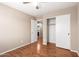 Bedroom featuring hardwood floors, neutral walls, ceiling fan and two closet spaces near a doorway leading to a bathroom at 25732 W Elizabeth Ave, Buckeye, AZ 85326