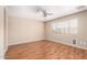 The bedroom features laminate flooring, neutral walls, and a ceiling fan with light fixture at 25732 W Elizabeth Ave, Buckeye, AZ 85326