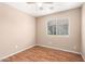 This cozy bedroom offers ample natural light with hardwood flooring and neutral walls for a calm space at 25732 W Elizabeth Ave, Buckeye, AZ 85326