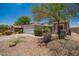 Charming single-story home featuring a two-car garage, solar panels, and desert landscaping at 25732 W Elizabeth Ave, Buckeye, AZ 85326