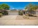 Charming single-story home featuring a two-car garage, solar panels, and desert landscaping at 25732 W Elizabeth Ave, Buckeye, AZ 85326
