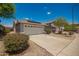Single-story home with a two-car garage and low-maintenance desert landscaping at 25732 W Elizabeth Ave, Buckeye, AZ 85326