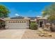 Charming single-story home featuring a two-car garage, solar panels, and desert landscaping at 25732 W Elizabeth Ave, Buckeye, AZ 85326