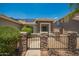 Front porch with stone pillars, metal gate and desert landscaping at 25732 W Elizabeth Ave, Buckeye, AZ 85326