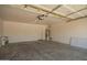 Spacious garage with concrete floor and a water heater at 25732 W Elizabeth Ave, Buckeye, AZ 85326