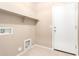 Functional laundry room featuring a door, and hookups for laundry machines and added storage space at 25732 W Elizabeth Ave, Buckeye, AZ 85326