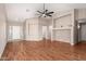 Spacious living room with hardwood floors and vaulted ceiling and ceiling fan fixture at 25732 W Elizabeth Ave, Buckeye, AZ 85326