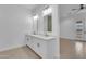 Bright bathroom with double vanity, stylish mirrors, and tiled floors, offering a modern and spacious design at 28834 N 175Th Ave, Surprise, AZ 85387