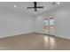 Spacious bedroom with neutral walls, modern ceiling fan, recessed lighting, and french doors at 28834 N 175Th Ave, Surprise, AZ 85387