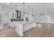 Modern kitchen showcases white cabinets, a large island with marble countertop, and stainless steel appliances at 28834 N 175Th Ave, Surprise, AZ 85387