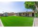 Spacious backyard with artificial grass, storage shed, and covered patio, ideal for outdoor living at 3010 E Yucca St, Phoenix, AZ 85028