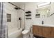Bathroom with modern fixtures, vanity, and tiled shower-tub provides a serene and practical space at 3010 E Yucca St, Phoenix, AZ 85028