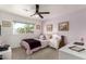 Cozy bedroom with a ceiling fan, a window view, and unique decor creates a comfortable space at 3010 E Yucca St, Phoenix, AZ 85028