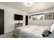 Clean bedroom featuring a large window, neutral decor, and dark trim at 3010 E Yucca St, Phoenix, AZ 85028