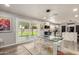 Contemporary dining area with a glass table, clear chairs, and sliding glass doors to the backyard at 3010 E Yucca St, Phoenix, AZ 85028