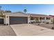 Well-kept home features a two-car garage, low-maintenance desert landscaping, and a neutral color scheme at 3010 E Yucca St, Phoenix, AZ 85028