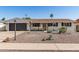 Charming single-story home featuring desert landscaping, a two-car garage, and a neutral color palette at 3010 E Yucca St, Phoenix, AZ 85028