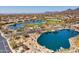Aerial view of serene lakes, golf course, and beautiful community, highlighting the area's natural beauty and outdoor lifestyle at 33667 N 71St Way, Scottsdale, AZ 85266