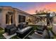 Beautiful backyard with a fire pit, outdoor kitchen, and a water feature with a seating area and modern accents at 33667 N 71St Way, Scottsdale, AZ 85266