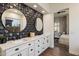 Bathroom featuring modern vanity, black fixtures and geometric accent wall at 33667 N 71St Way, Scottsdale, AZ 85266