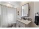 Compact bathroom with decorative mirror and shower curtain at 33667 N 71St Way, Scottsdale, AZ 85266