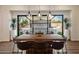 Dining area featuring a rustic wooden table, modern pendant lights, and scenic outdoor views at 33667 N 71St Way, Scottsdale, AZ 85266
